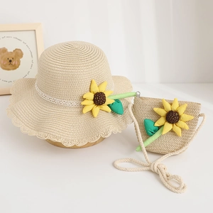 Detailed view of children's straw sun hat and matching bag set with sunflower.