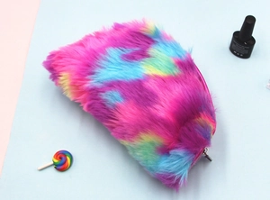 Close-up of rainbow plush pencil case with zipper closure and colorful props