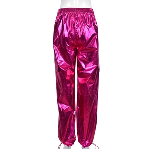 Detail of rose pink metallic cargo pants showing elastic waistband and shiny fabric