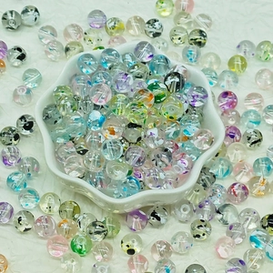 Macro shot of colorful floating floral pattern glass beads for DIY jewelry making