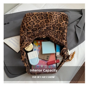 Close-up of spacious leopard print tote interior holding a tablet and daily essentials