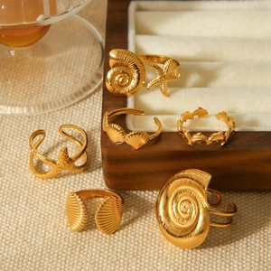 Golden ocean theme stainless steel ring set featuring starfish and seashell designs