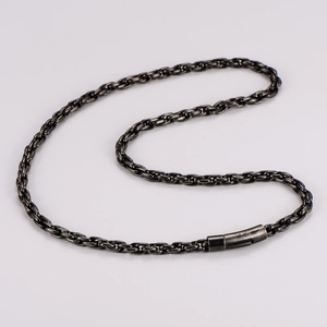 Detail of vintage stainless steel braided link chain necklace with clasp in retro style