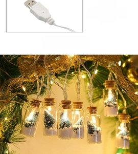 Close-up of USB powered LED glass wishing bottle light with miniature Christmas tree inside