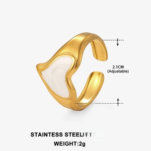 Detail of adjustable gold stainless steel ring with white heart enamel showing 2g weight