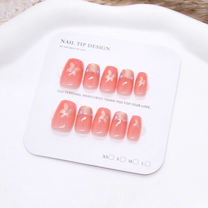 Pink gradient press-on nails with golden butterfly, purple flowers and glitter