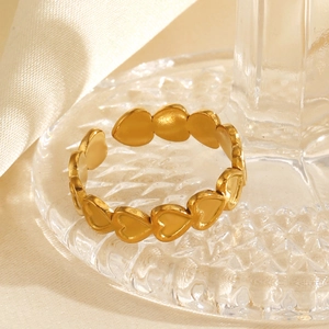 18K gold-plated stainless steel heart open ring on elegant textured glass surface