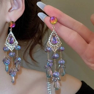 Detailed close-up of Bohemian purple crystal tassel earrings with sparkling rhinestones