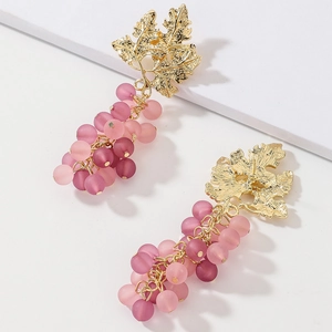 Detailed view of pink and purple frosted grape earrings with golden leaf accents