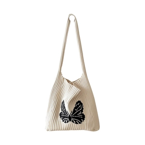 Elegant white knitted tote bag with a striking black butterfly pattern on a clean background