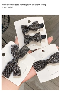 Close-up of four-piece black rhinestone bow hair clip set with sparkling crystals