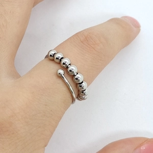 Detail of silver anxiety ring with ten rotatable beads on adjustable open band