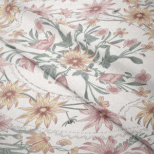 Detailed close-up of vintage floral patterns on soft beige fabric with natural texture