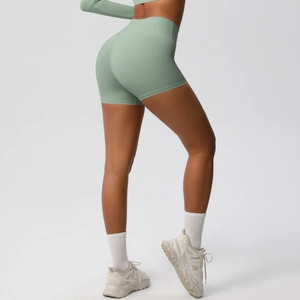Rear view of bean green high waist yoga shorts showing seamless texture and lifting effect