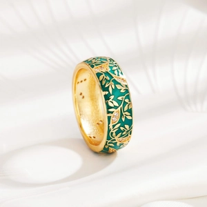 Detail of gold floral ring with green enamel, leaf patterns and sparkling crystals