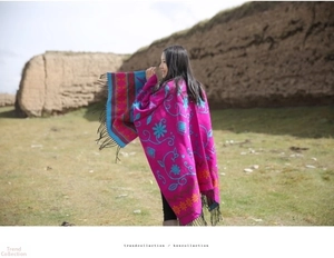 Detailed embroidery on ethnic fuchsia cashmere shawl with turquoise floral and black tassels