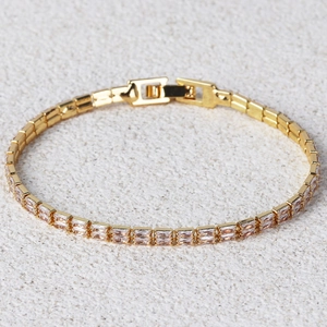 Elegant gold-plated double-row bracelet with rectangular pink zircons on rock texture