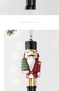 Detail of Nutcracker soldier ornament with red uniform and mini Christmas tree decoration