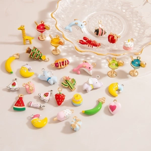 Macro shot of assorted colorful enamel animal and fruit alloy charms for DIY jewelry making