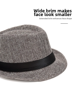 Detailed close-up of breathable grey straw fedora hat with wide brim and black ribbon band