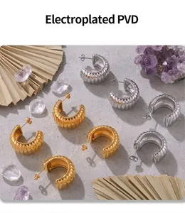 Detailed macro view of PVD electroplated gold and silver textured C-shaped stud earrings