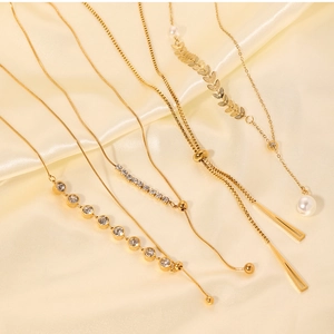 Detailed display of five gold plated necklaces featuring pearls, zircons and opal pendants