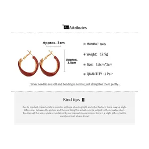 Detailed view of red twist hoop earrings with dimensions and material specifications