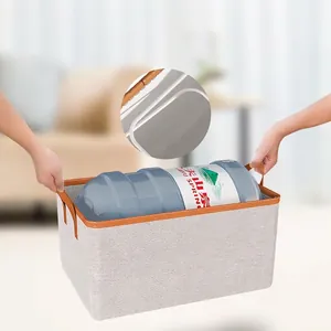 Grey storage box with reinforced steel frame and leather handles for closet organizing