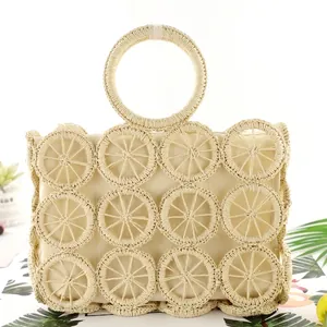 Handmade woven straw tote bag with round hollow design and stylish circular top handles