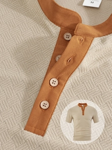 Detail of waffle knit fabric and brown henley collar on a beige short sleeve men shirt
