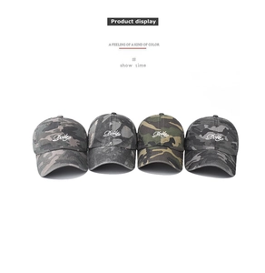 Detail display of vintage camo baseball caps with white embroidered lettering and twill texture
