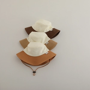 Detail of color-block sun hats with adjustable windproof drawstrings and wide brims