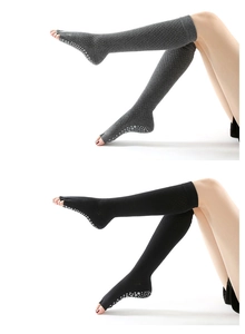 Close-up of over-knee five-toe yoga socks in grey and black with anti-slip grip soles