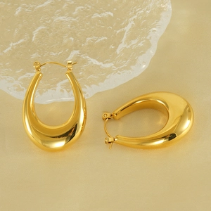 Polished 18K gold-plated stainless steel U-shaped teardrop earrings on a velvet background