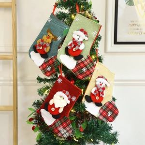 Set of four cartoon Christmas stockings with Santa, Snowman and Reindeer on a festive tree