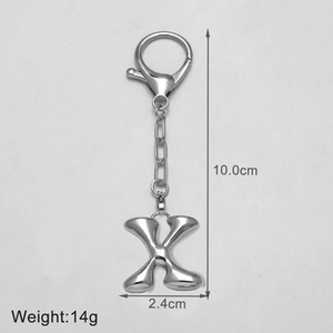 Detail view of silver 3D letter X keychain with dimensions 10cm length and 14g weight