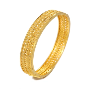 Golden hollowed flower pattern wedding bangle with intricate beadwork and wave edges
