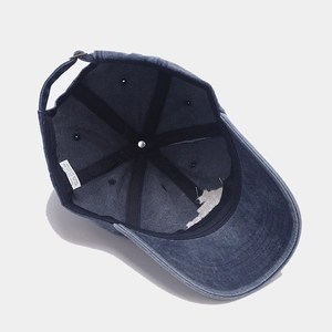 Inside view of washed denim baseball cap featuring 100% cotton material and adjustable buckle