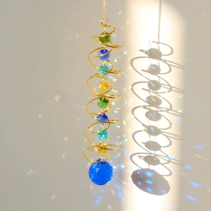 Macro detail of golden spiral wind chime casting colorful rainbow spots on the wall