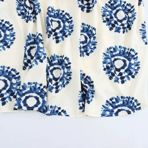 Boho halter maxi dress with blue shibori geometric tie-dye prints on a white fabric hem