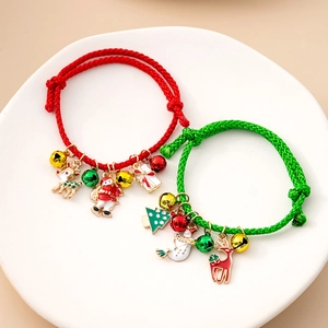 Detailed shot of Christmas bracelets with reindeer and santa charms on a ceramic tray