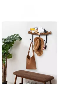 Detailed view of Nordic chef wall hook rack holding a bag, hat and keys in a home hallway
