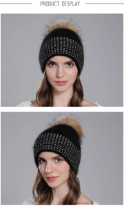 Detail view of women's black knit winter beanie with premium raccoon fur pompom and silver dots