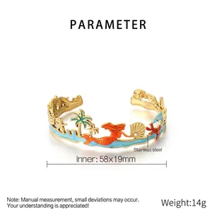 Detail of ocean-themed gold stainless steel cuff with starfish and palm tree enamel charms