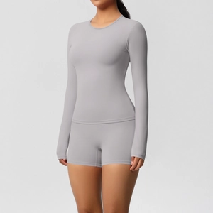 Detail of light grey yoga set showing high-waist shorts and long sleeve stretch top