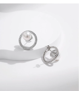 Detail of S925 silver stud earrings with geometric crystal halo and white pearl