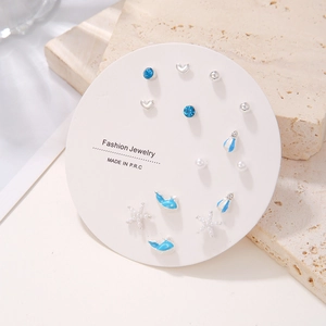 Detailed set of 7 pairs of silver and blue stud earrings with whale and starfish designs