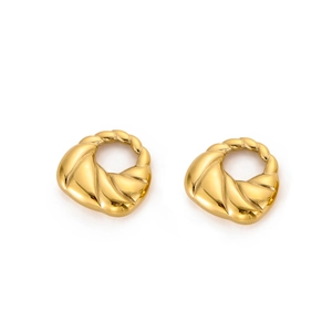 Close-up of twisted texture gold metal earrings with a glossy studio finish