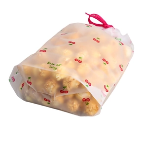 Frosted plastic drawstring storage bag with cherry print and red drawstring closure