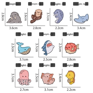 Size chart showing weight and dimensions for sea creature enamel pins like shark and whale
